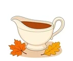 Classic cream gravy boat filled with brown gravy beside two large autumn leaves.