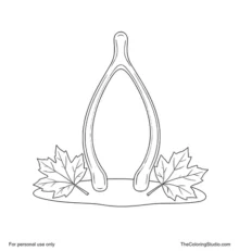Large curved wishbone resting above two autumn leaves on a small simple ground patch.