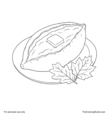 Baked sweet potato split open with a butter pat on a cream plate beside two autumn leaves.
