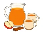 Glass pitcher of amber apple cider with two cream cups, a red apple slice, and two cinnamon sticks.
