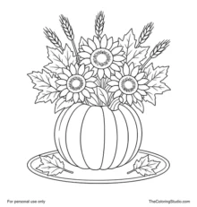 Pumpkin vase centerpiece with three sunflowers, wheat stems, autumn leaves, and two loose leaves on a small mat.